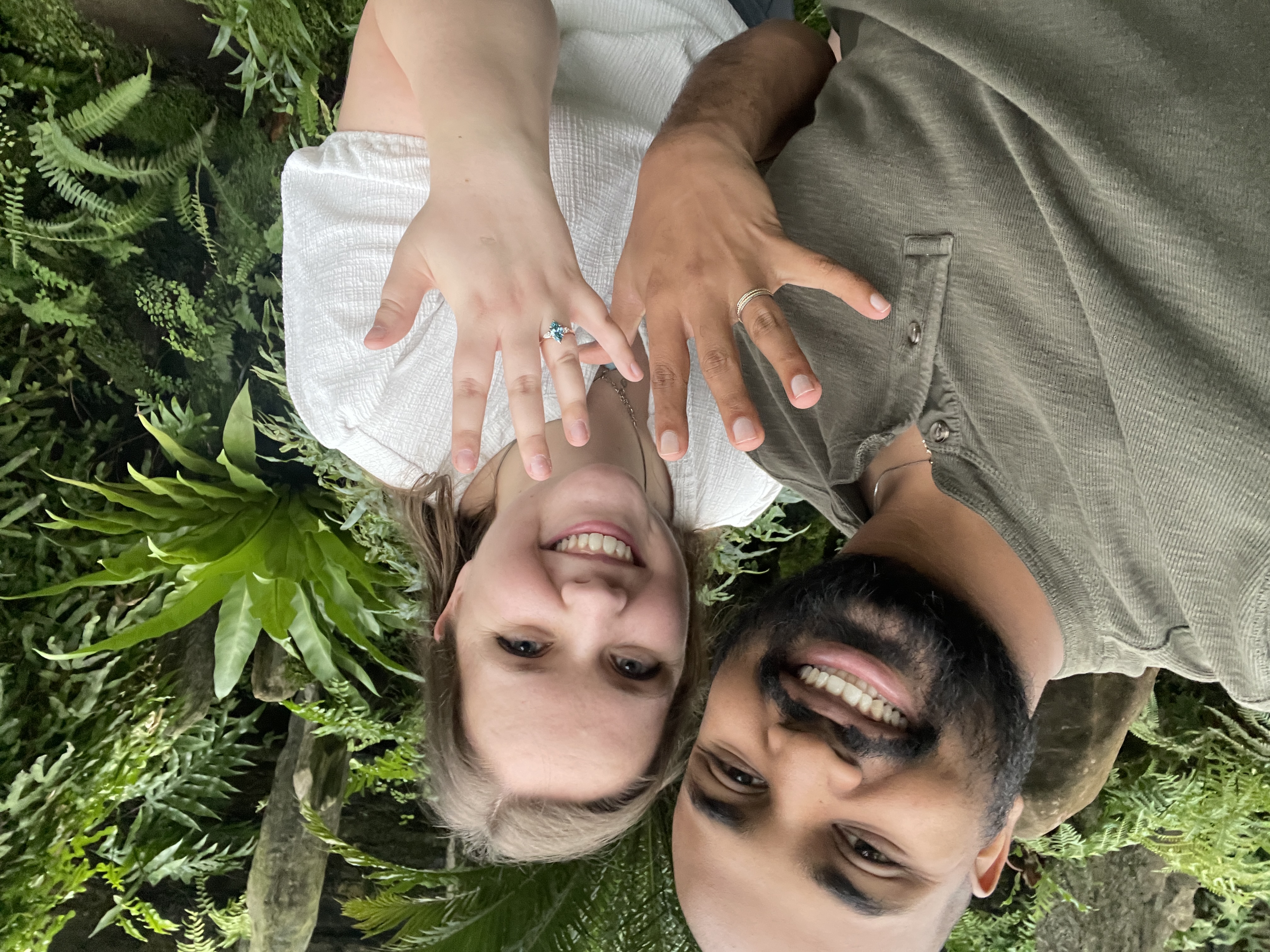 Ariel and Vai showing their rings while lying among greenery